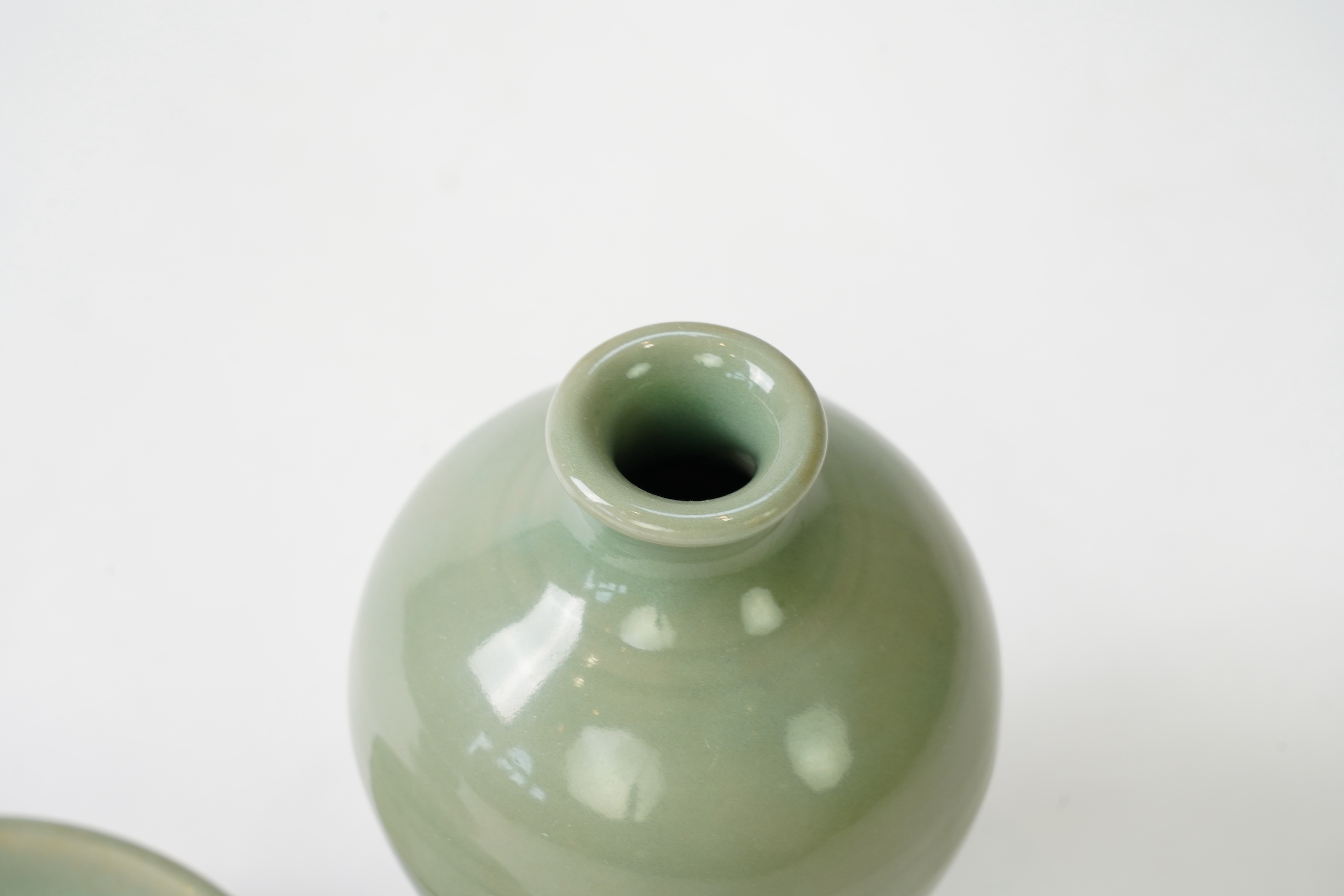 A group of four Chinese Celadon wares - two vases and two dishes, tallest vase 16cm.